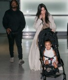 Giggling North West can't contain her delight as she lands in Paris with parents Kim Kardashian and Kanye West after her baptism in Jerusalem