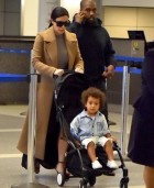 Kim Kardashian and Kanye West look jet-lagged as they arrive back at LAX with North ...after three-country tour in just eight days