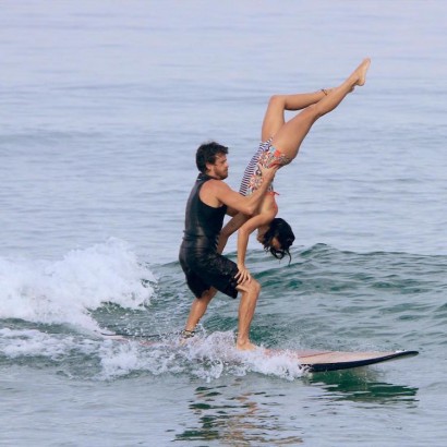 Surfing Couple Making Waves By Performing Impressive Tricks on a Single Board Like Earthables on Facebook