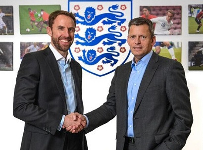 Former defender signs four-year deal to lead Three Lions
