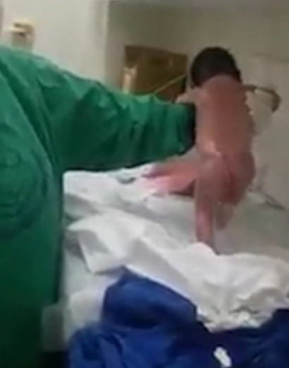 Look who's walking! Newborn baby's incredible first steps just minutes after leaving the womb