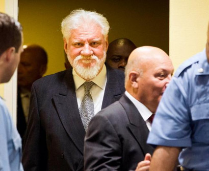 Bosnian Croat war crimes suspect 'drinks poison' at Hague hearing