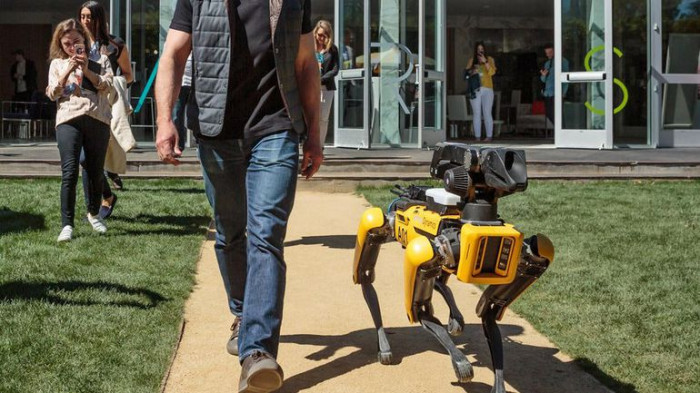 Amazon founder Jeff Bezos takes a robot dog for a walk