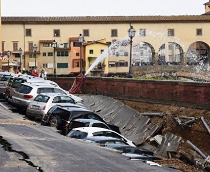 Dozens of cars are swallowed up in massive 600ft road collapse along river in Florence after underground water pipe bursts
