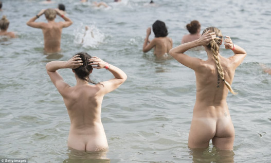 Beach bums! More than a thousand skinny dippers bare it all in the annual nude swim in Sydney
