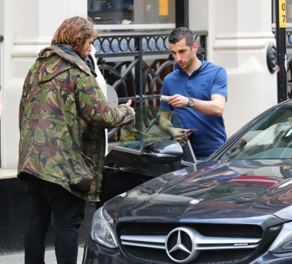 Henrikh Mkhitaryan dodges traffic warden's challenge to assist a homeless man on Manchester city centre trip