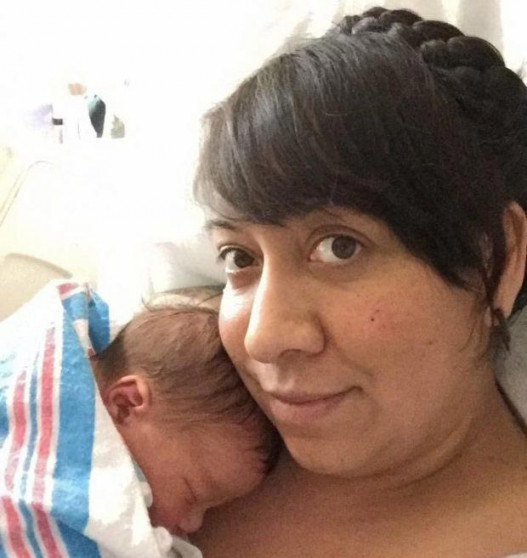 Newborn clutches his mother's hormonal coil in ironic snap