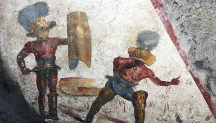 Pompeii dig unearths fighting fresco in 'gladiators' tavern'