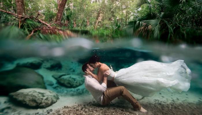 A breathtaking picture of newlyweds kissing underwater was a 'dream come true' for the photographer