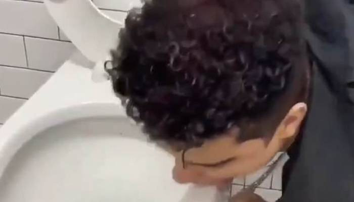 California 'influencer' says he is in hospital with coronavirus just days after posting a video of himself licking a toilet bowl for a revolting TikTok challenge