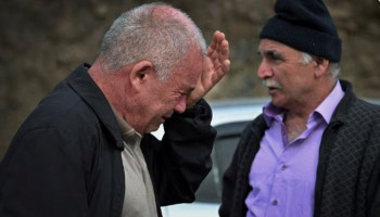 Eduard Ghahramanyan, father of Reuters freelance photographer David Ghahramanyan, reacts as they leave Nagorno-Karabakh region