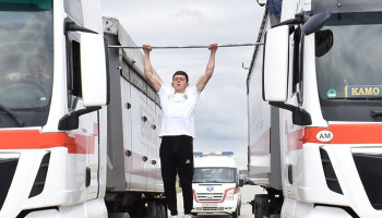 New record: Most consecutive pull ups on a bar positioned between two moving trucks - 44 by Grigor Manukyan