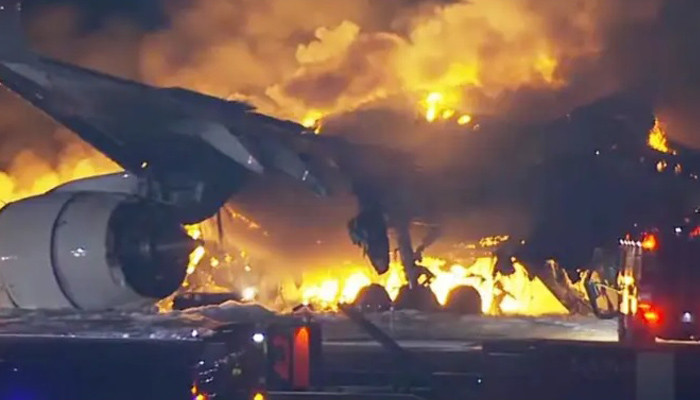 Japan Airlines plane in flames on runway at Tokyo's Haneda airport