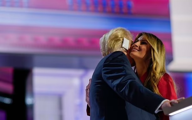 Melania Trump stuns in red as she walks into the Republican convention to a roaring crowd to watch husband Donald speak