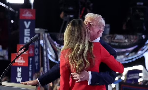 Melania Trump stuns in red as she walks into the Republican convention to a roaring crowd to watch husband Donald speak