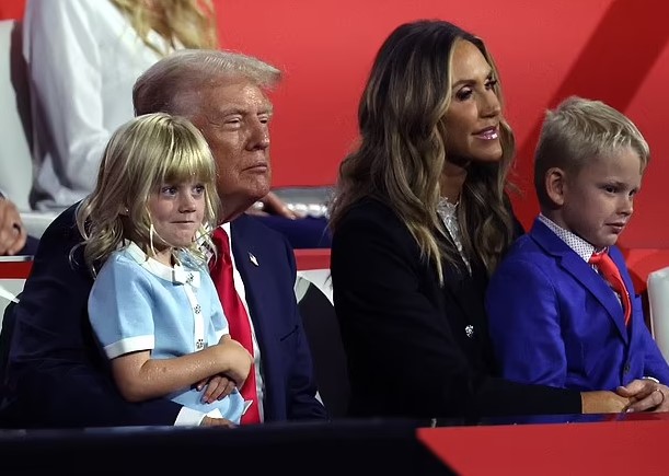 Melania Trump stuns in red as she walks into the Republican convention to a roaring crowd to watch husband Donald speak